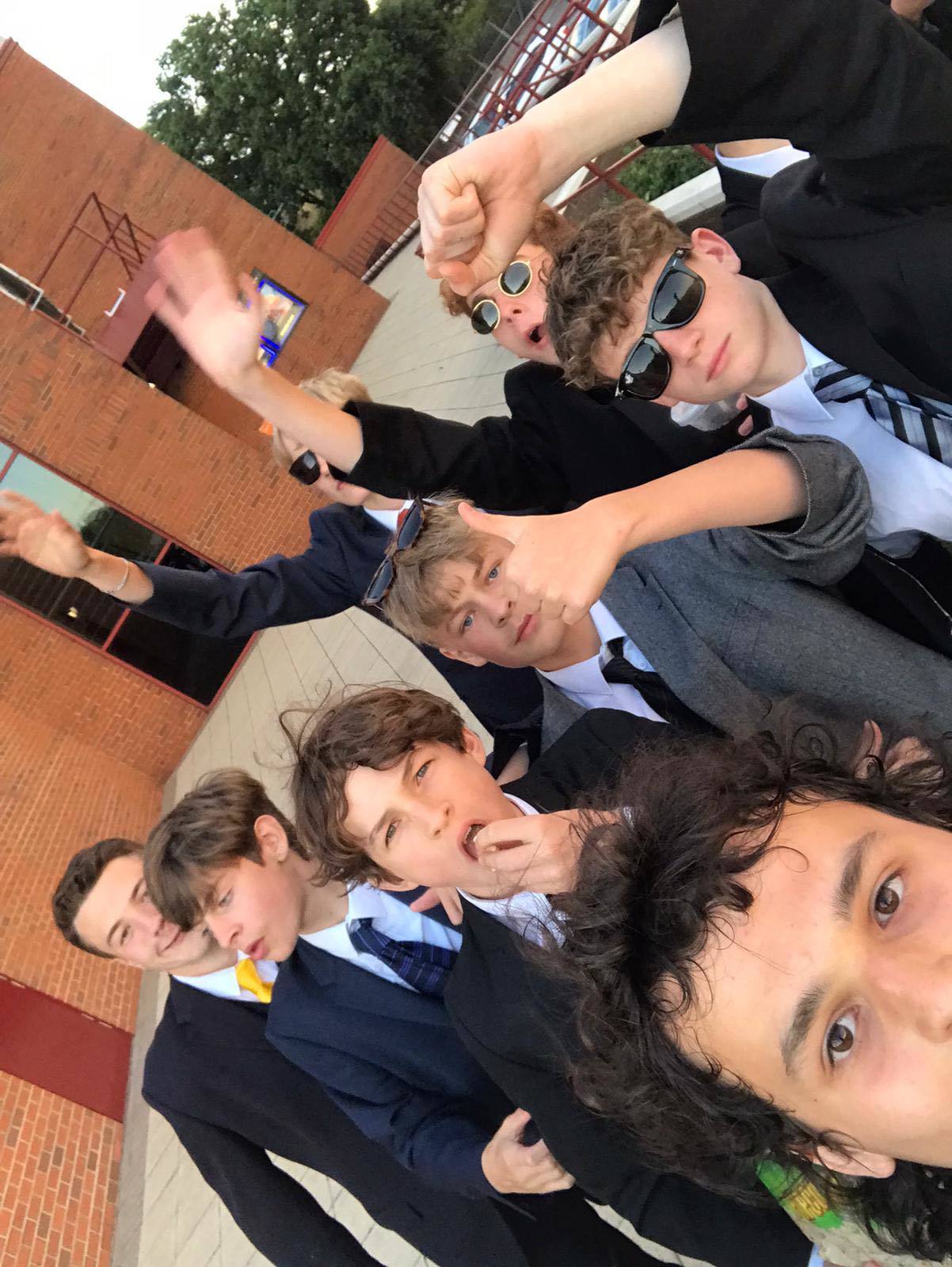 Ryan Wade, 13, poses with the suited and booted teenagers outside Showcase Cinema